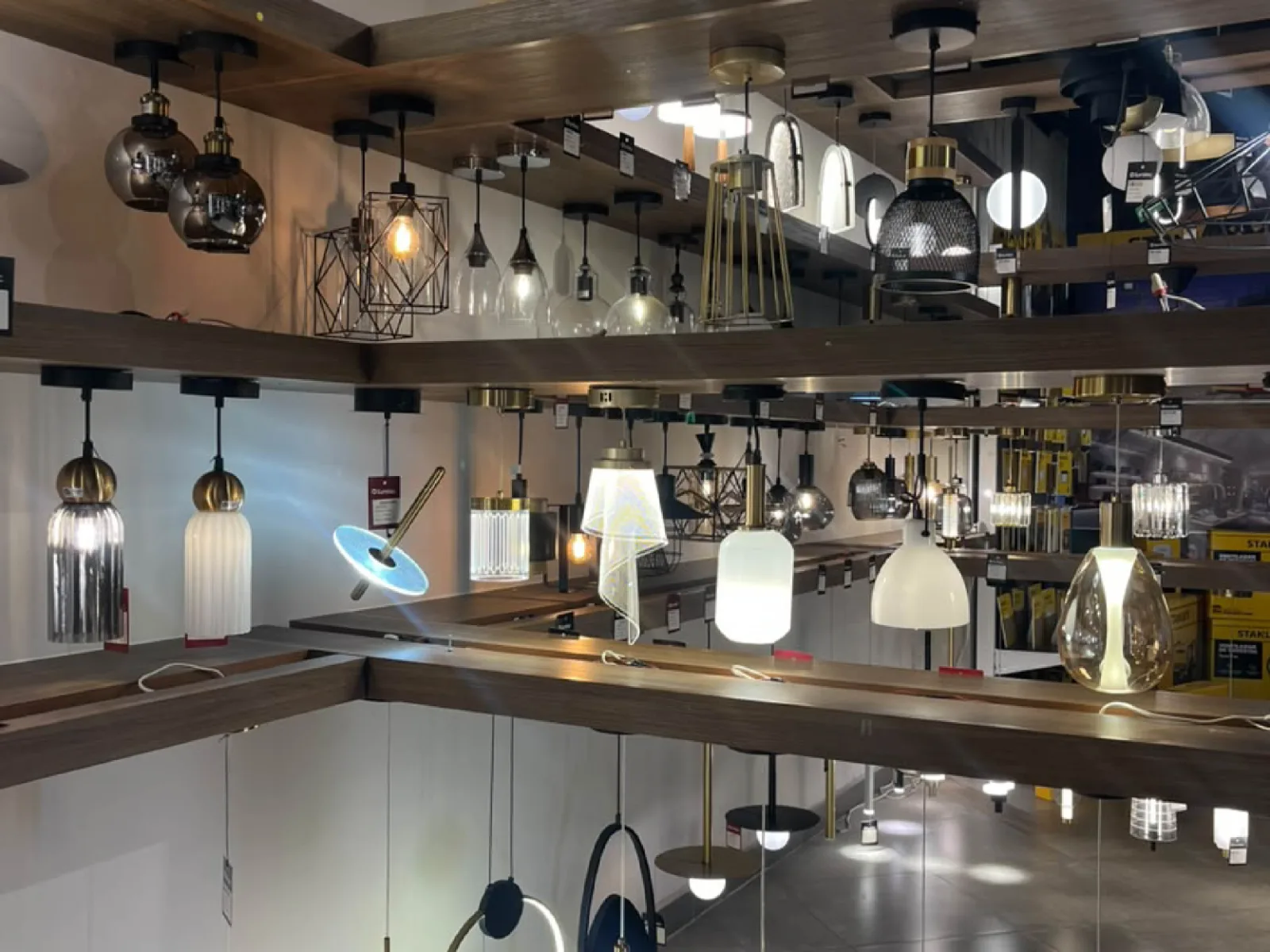 Ilumitec showroom featuring a variety of decorative lighting fixtures and ceiling fans.