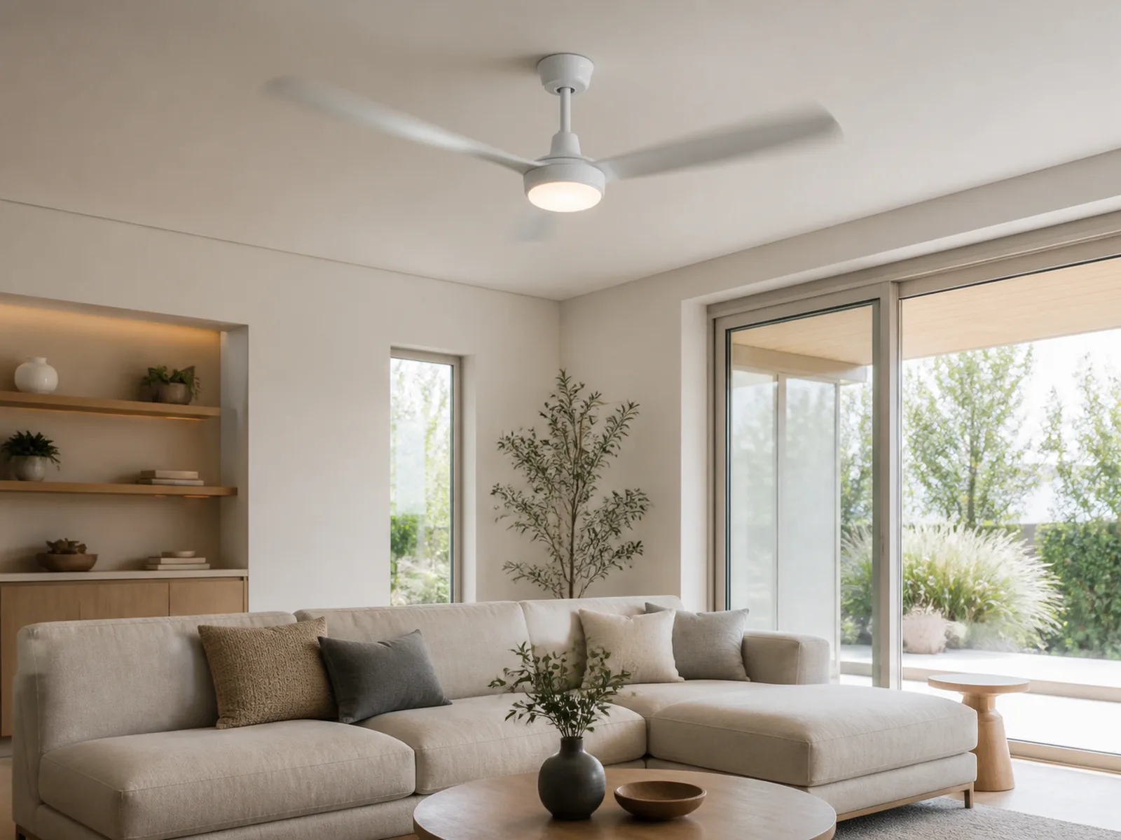 White ceiling fan with integrated LED light in a bright modern living room.